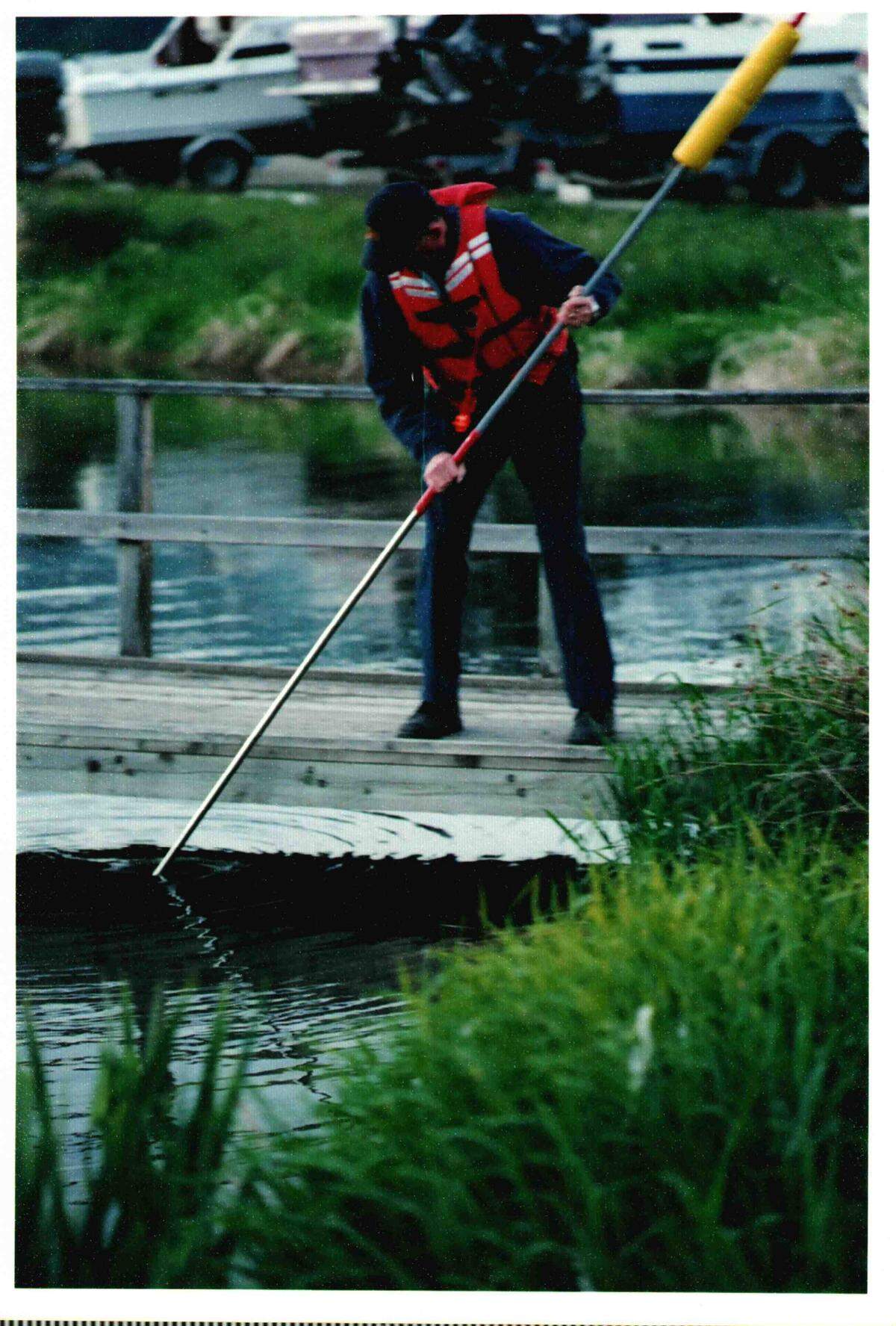 Volunteer firefighter Ron Swanson uses pole to search for a possible drowning victim during a summer 2004 training exercise at the Sudden Valley marina.