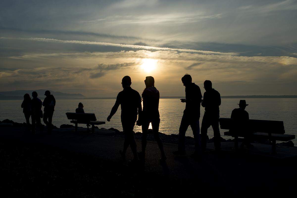 People enjoy the sunset at Boulevard Park on Wednesday, Sept. 5, in Bellingham. 
