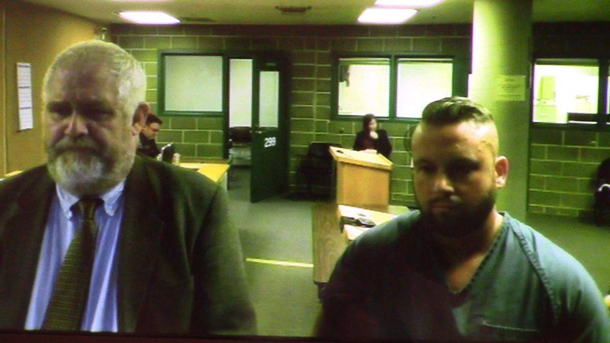 Bellingham Police Cpl. Brooks Owen Laughlin, 33, of Everson, right, appears in Whatcom County Superior Court Wednesday, March 28, with Defense attorney Doug Hyldahl.