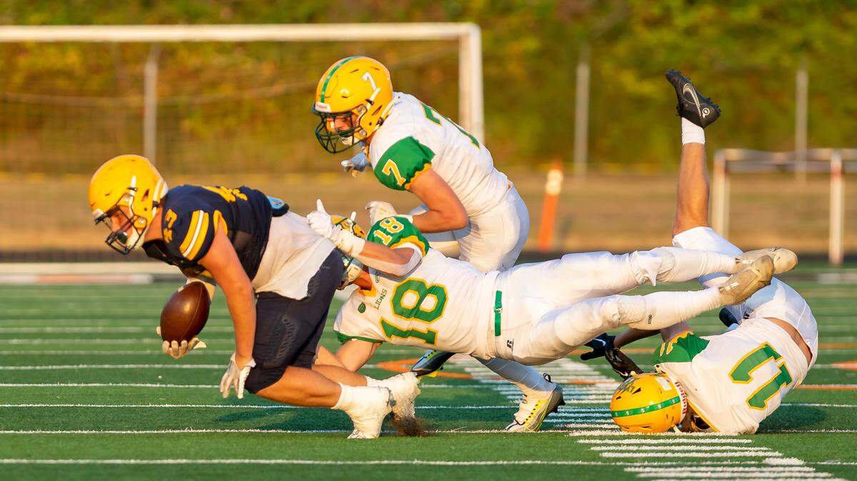 Lynden defensive players Colin Anker (18), Trey Smiley (7), and Troy Petz (11) stop Ferndale running back Jason Nowak (43) behind the line of scrimmage during the first quarter of their season opener on Friday evening Sept. 2, at Blaine High School. This week, Lynden meets Anacortes at 7 p.m. Friday in Week Nine of prep football play for the Northwest Conference 2A.