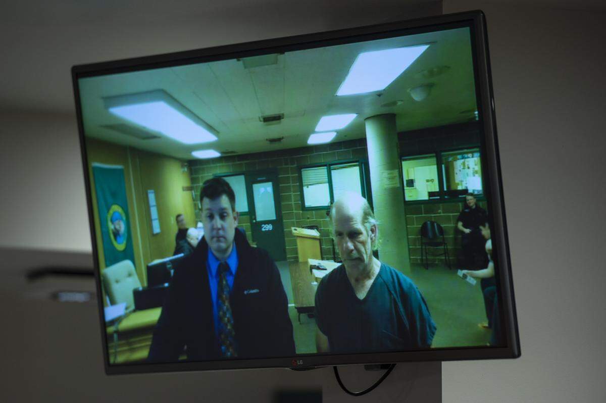 Public defender Darrin Hall, left, stands alongside Paul Wolfe, who is suspected of starting the Feb. 18 fire that destroyed Hohl Feed & Seed, during his first appearance at Whatcom County Superior Court Thursday.