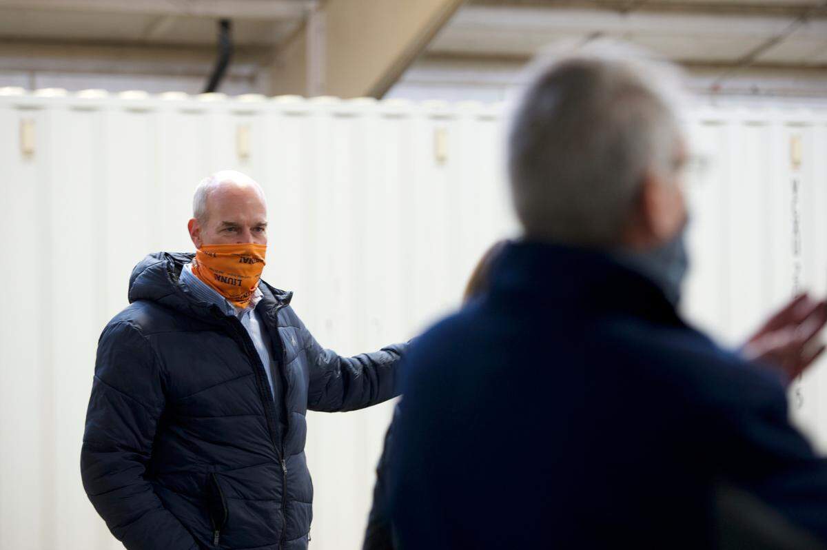 Rep. Rick Larsen, D-Everett, left, discusses COVID-19 vaccine distribution with Whatcom County and Whatcom Health Department officials at the drive-up testing site at the Northwest Fairgrounds on Monday, Dec. 14, in Lynden.