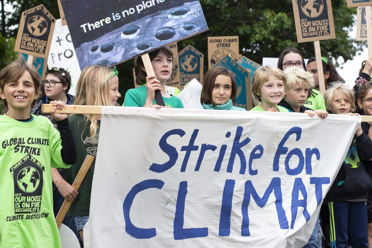 Students lead a crowd of about 2,500 people on a march for climate action after a rally outside of Bellingham City Hall Friday.