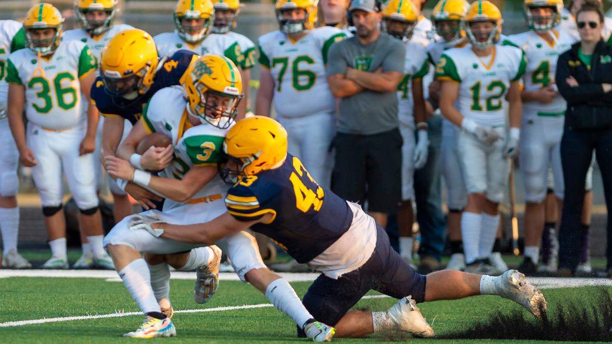 Lynden quarterback Kaedan Hermanutz (3) is stopped at the line of scrimmage by Ferndale defensive backs Bishop Ootsey (3) and Jason Nowak (43) in the first quarter during their first varsity football game on Friday evening Sept. 2, at Blaine High School. Lynden defeated Ferndale 24 to 7.