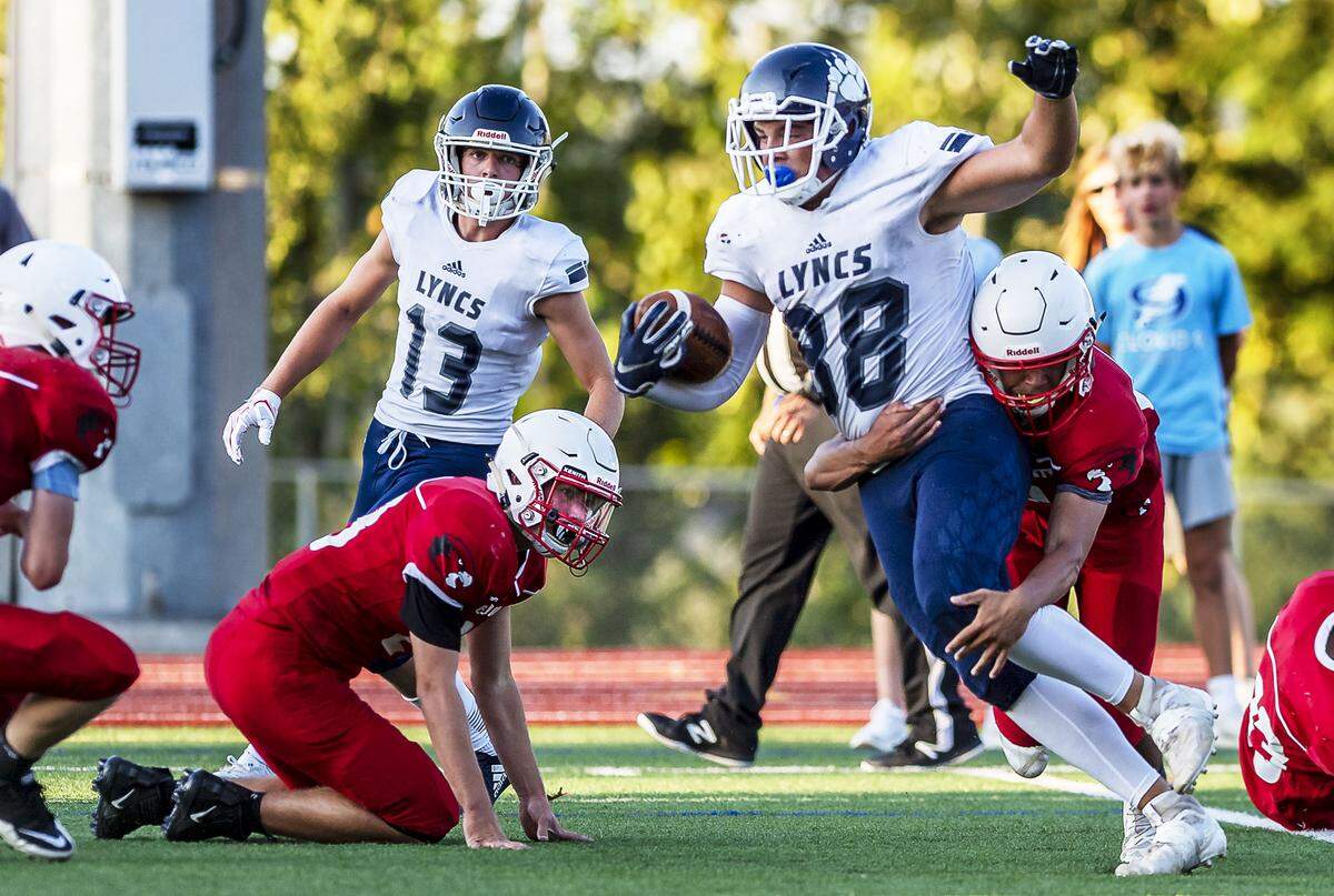 Bellingham cornerback Andre Triplett attempts to stop Lynden Christian wide receiver Zach Sipma Sept. 6 at Civic Stadium. Sipma, along with Bryce Bouwman and Eli DenBleyker, has made unexpected contributions to the Lynden Christian football team’s run to the Class 1A state championship game. The Lyncs face Royal Saturday in Lakewood.