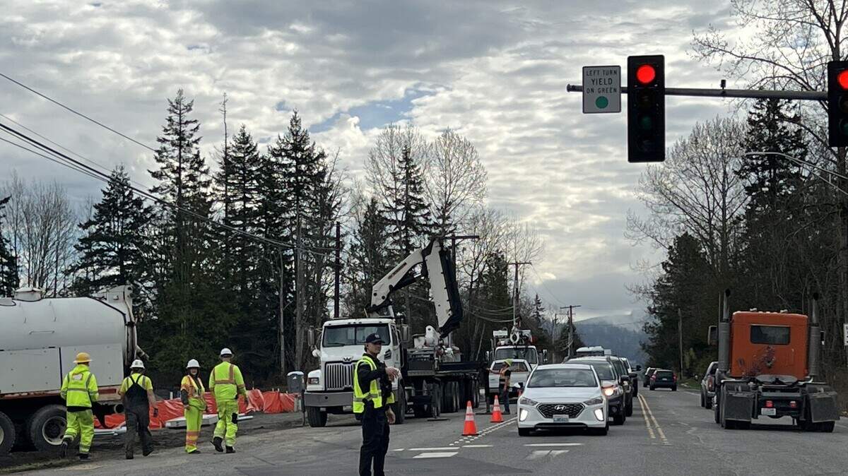 A flagger directs traffic on East Bakerview Road at James Street on Wednesday in Bellingham. A roundabout is being built at the busy intersection.