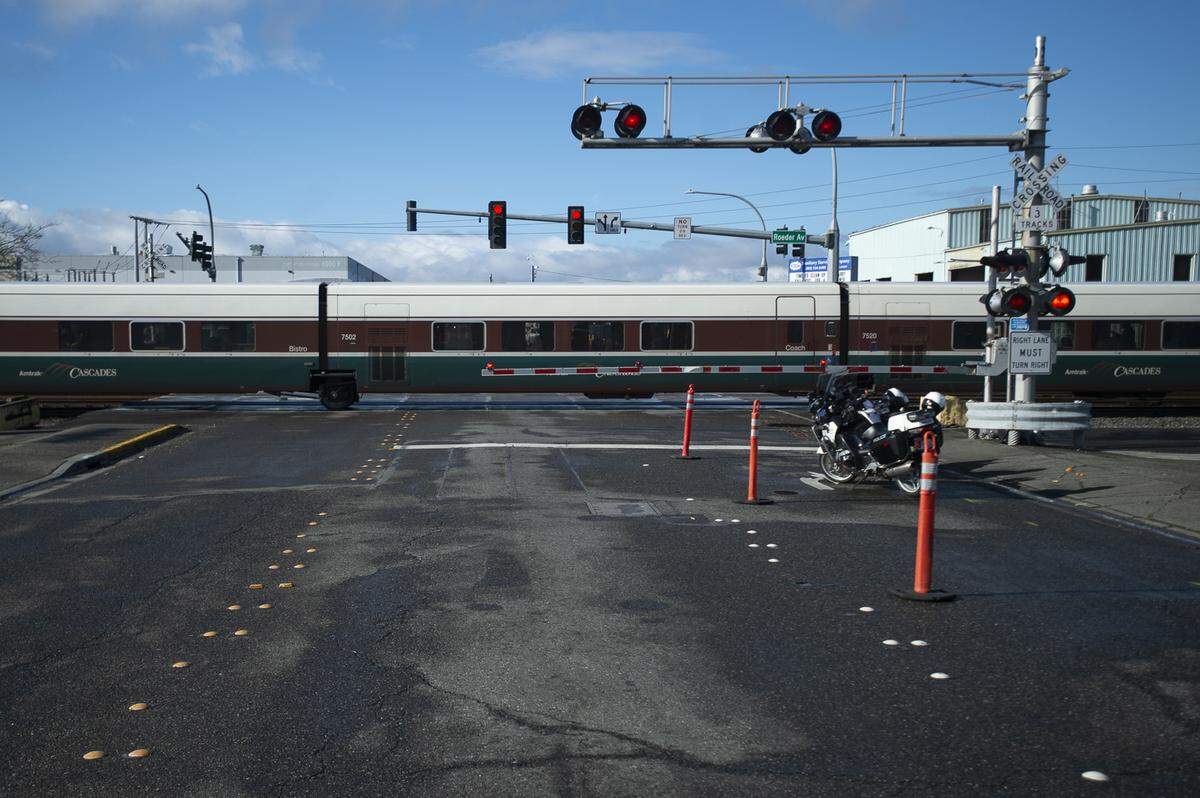 An Amtrak passenger train sits on the F Street crossing after a collision between the train and a bicyclist in Bellingham, Wash., on Tuesday, March 26, 2019.