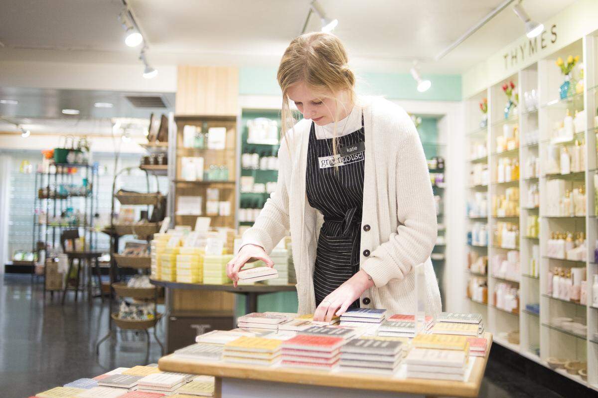 Greenhouse employee Katie Rosenfelt arranges a display of Bellingham-themed marble tiles on Friday in Bellingham.