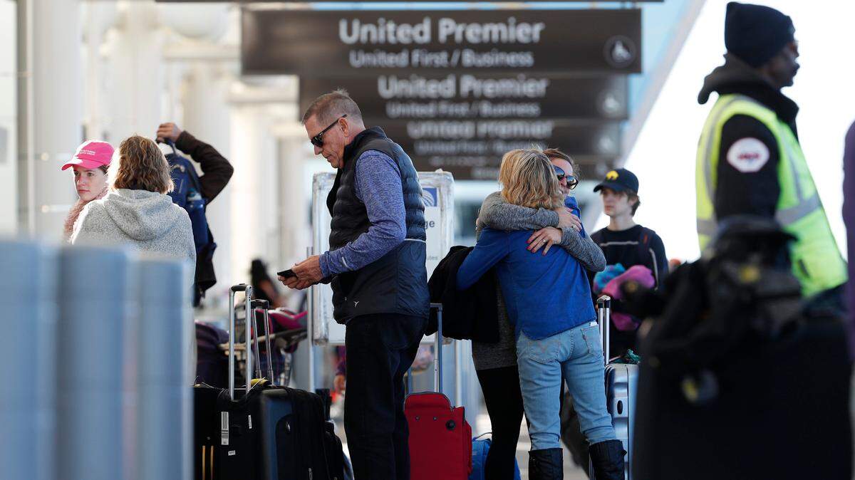 Women exchange farewells at the curbside baggage checkpoint outside the west gates of Denver International Airport, Wednesday, Nov. 21, 2018, in Denver. United Airlines will begin daily flights to Denver and San Francisco out of Paine Field in Everett, beginning March 31.