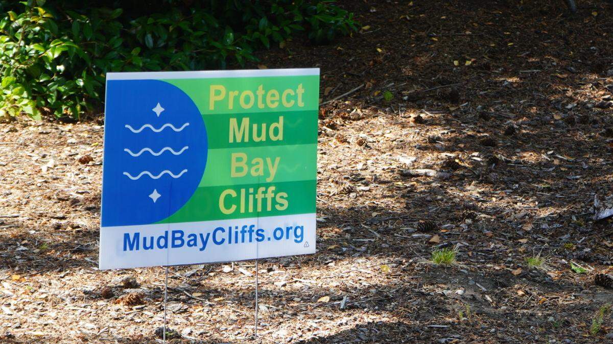 A ‘Protect Mud Bay Cliffs’ sign is posted in the front yard of an Edgemoor resident on July 6, 2023, in Bellingham, Wash.