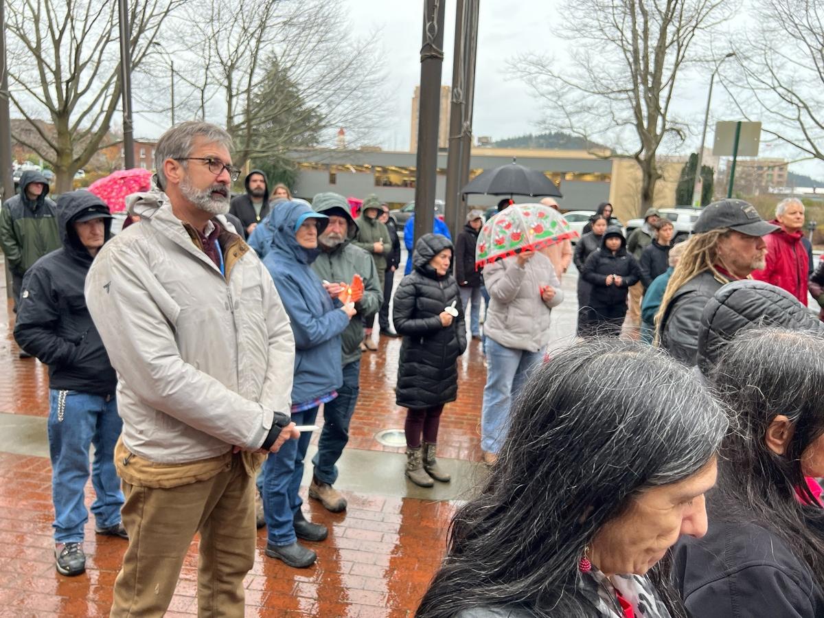 Bellingham City Council member Michael Lilliquist, left, joins about 100 others for a ceremony to honor National Homeless Persons Remembrance Day at City Hall plaza on Dec. 21.
