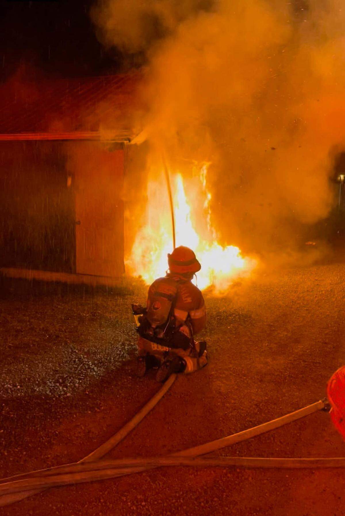 Bellingham firefighters work to extinguish one of two fires outside non-residential buildings of King Street Thursday, June 30, in Bellingham. Investigators believe the two fires are related and were set intentionally, as was an attempt at a third fire found between the two addresses.