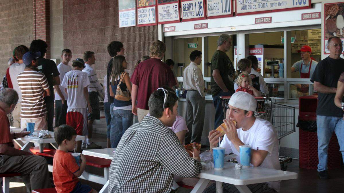 Customers dine at the Costco food court in Issaquah. Costco is planning to tweak its food court menu so that it can add some healthier choices. While the Polish dog is expected to go away, the $1.50 hot dog-soda combo will remain.