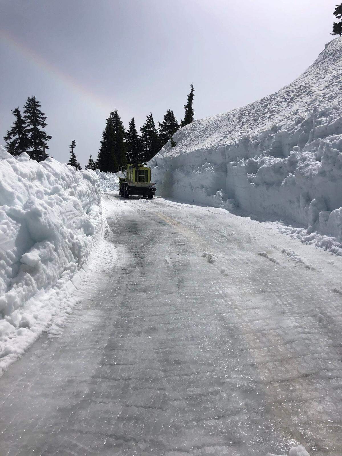A Washington State Department of Transportation snow-blower drives past a cleared section of the Mount Baker Highway east of Bellingham, where snow was 15 feet deep in early June.