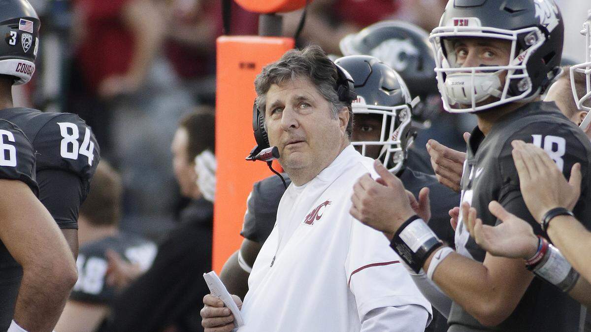Washington State head coach Mike Leach, center, watches a replay on the video screen at Martin Stadium during the Cougars’ 30-24 victory over Oregon in Pullman, Wash., on Saturday, Oct. 20, 2018.