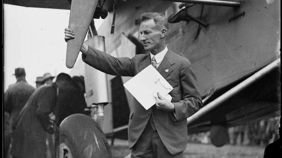 Australian pilot Charles Kingsford Smith with his plane. Smith would later disappear while trying to set a record flight from England to Australia in 1935 sparking a 90 year mystery.