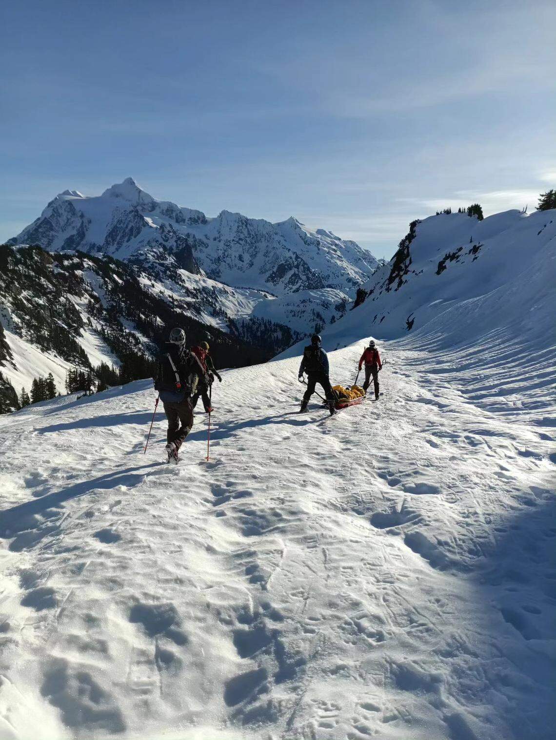 Volunteers with the Bellingham Mountain Rescue recovered a skier who was forced to spend a night in the mountains after injuring his ankle.