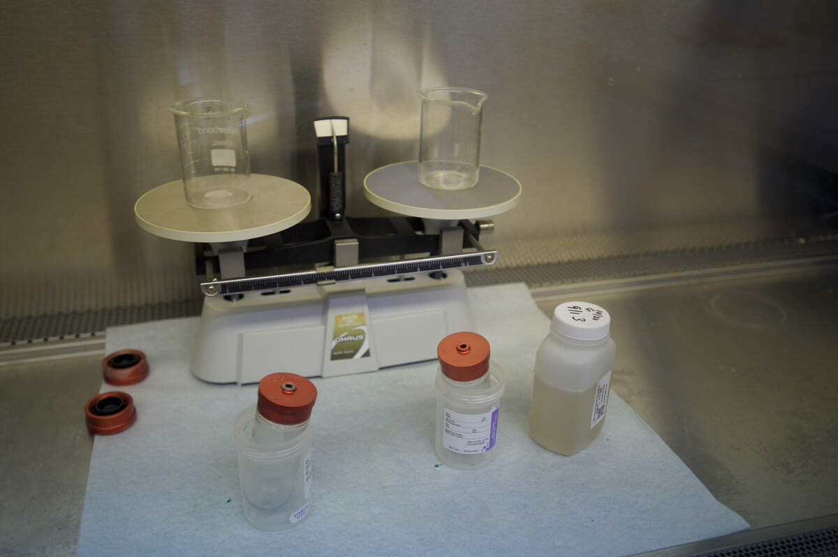 Test tubes and samples containing sewage sits in a fume-hood before being placed in an ultracentrifuge at Exact Science Labs on Oct. 30, in Ferndale.
