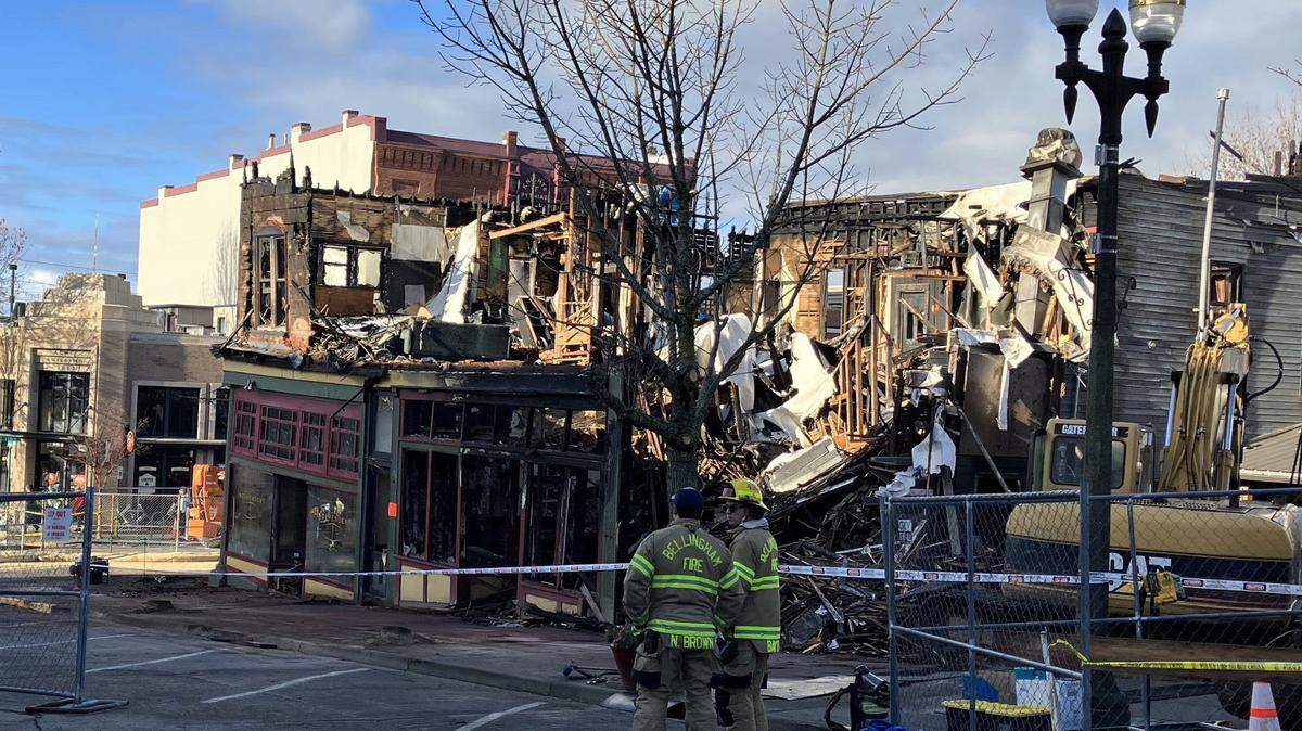 Bellingham firefighters are shown outside the ruins of the historic Terminal Building in the Fairhaven section of Bellingham. The building was destroyed by fire Dec. 16.