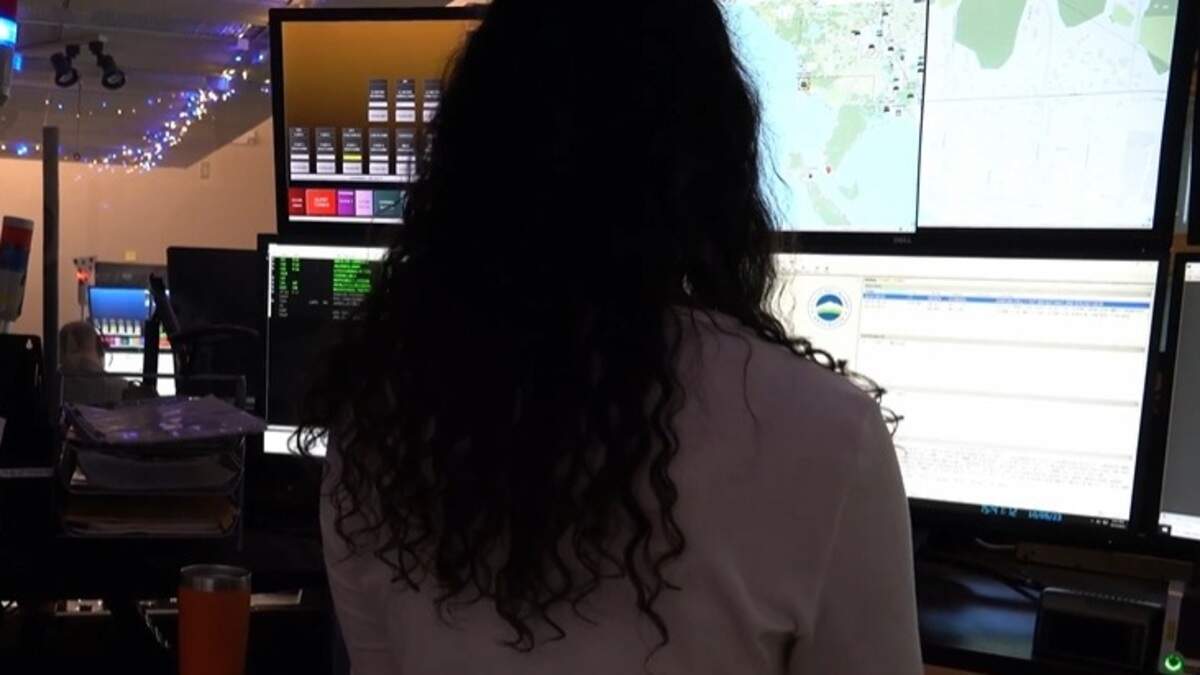 A What-Comm 911 dispatcher sits at a multiscreen terminal in a screenshot from a video “Answer the Call” produced by the Bellingham (Wash.) Police Department.