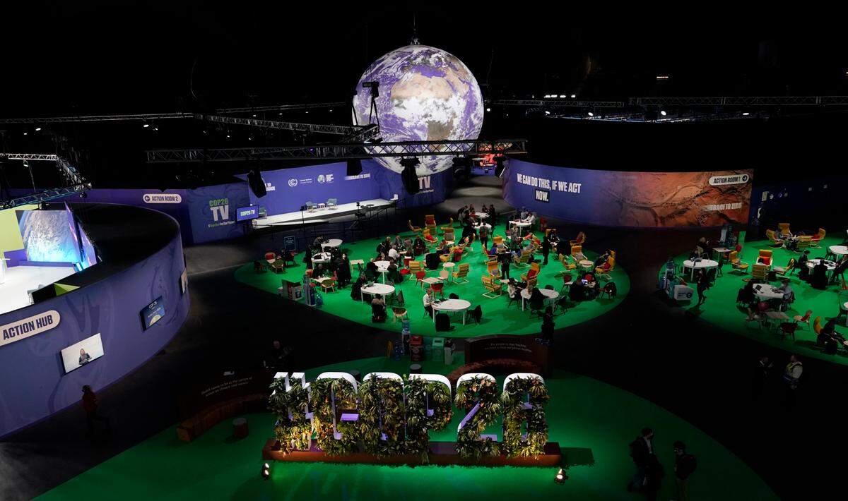 People gather in the Action Zone inside the venue for the COP26 U.N. Climate Summit in Glasgow, Scotland, Monday, Nov. 8. The U.N. climate summit in Glasgow is entering its second week as leaders from around the world, are gathering in Scotland’s biggest city, to lay out their vision for addressing the common challenge of global warming.