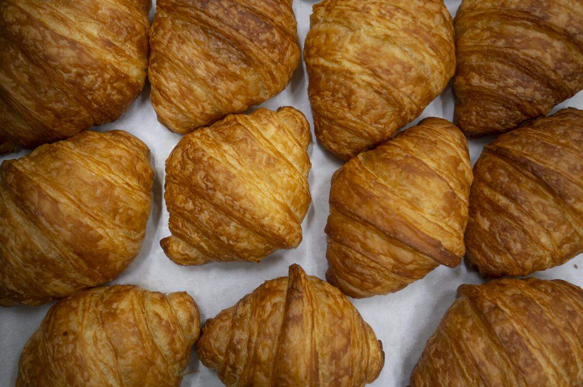 Baked croissants wait to be put on display and sold at the Iron Rooster Bakery in Fairhaven.