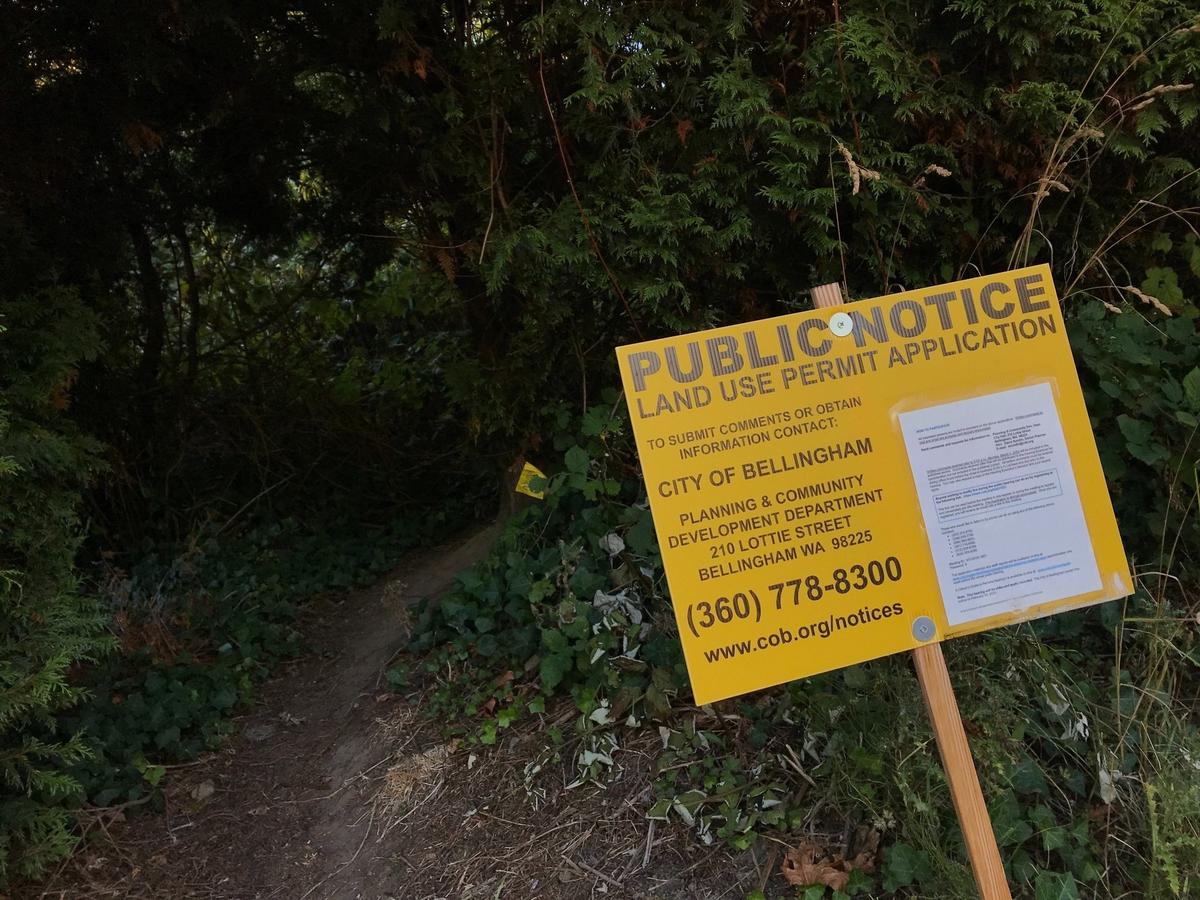 A city of Bellingham notice informs passers-by near the footpath at Douglas Avenue and 21st Street about the street vacation petition before the City Council in July.