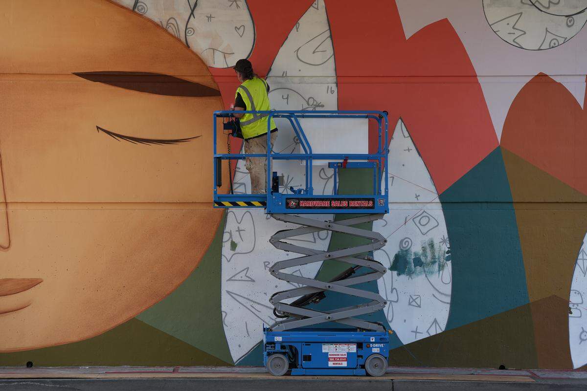 Denver-based street artist Jaime Molina works on his new mural on Lakeway Drive in Bellingham.