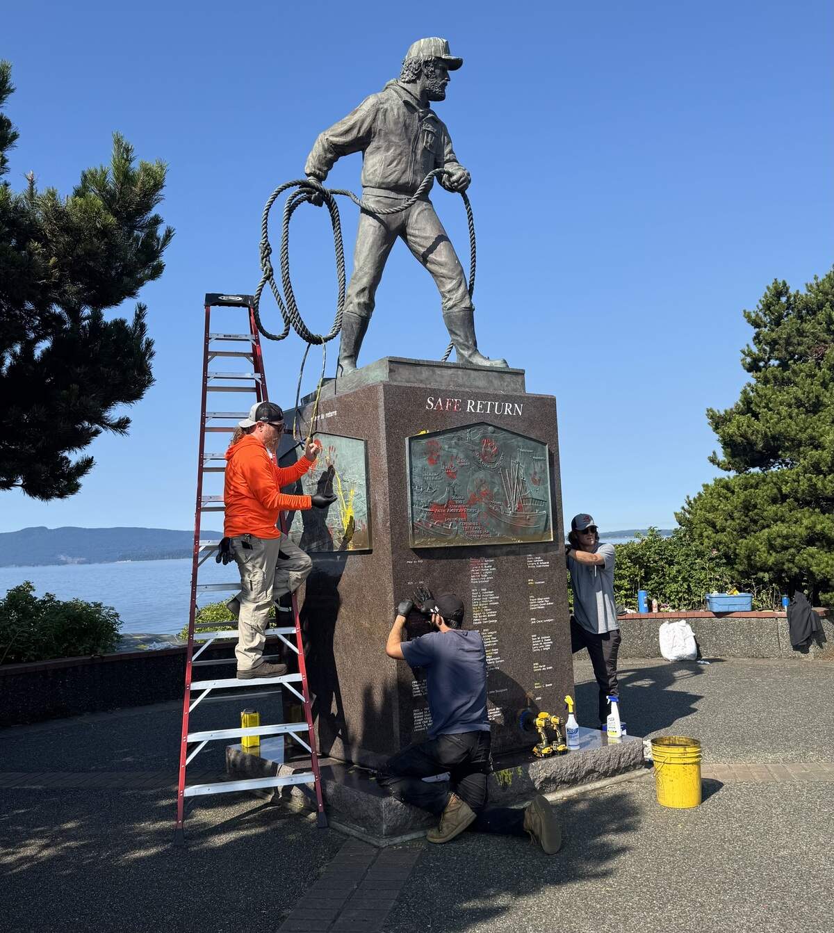 Workers clean up Safe Return, a memorial to deceased fisherman, at Zuanich Point Park.