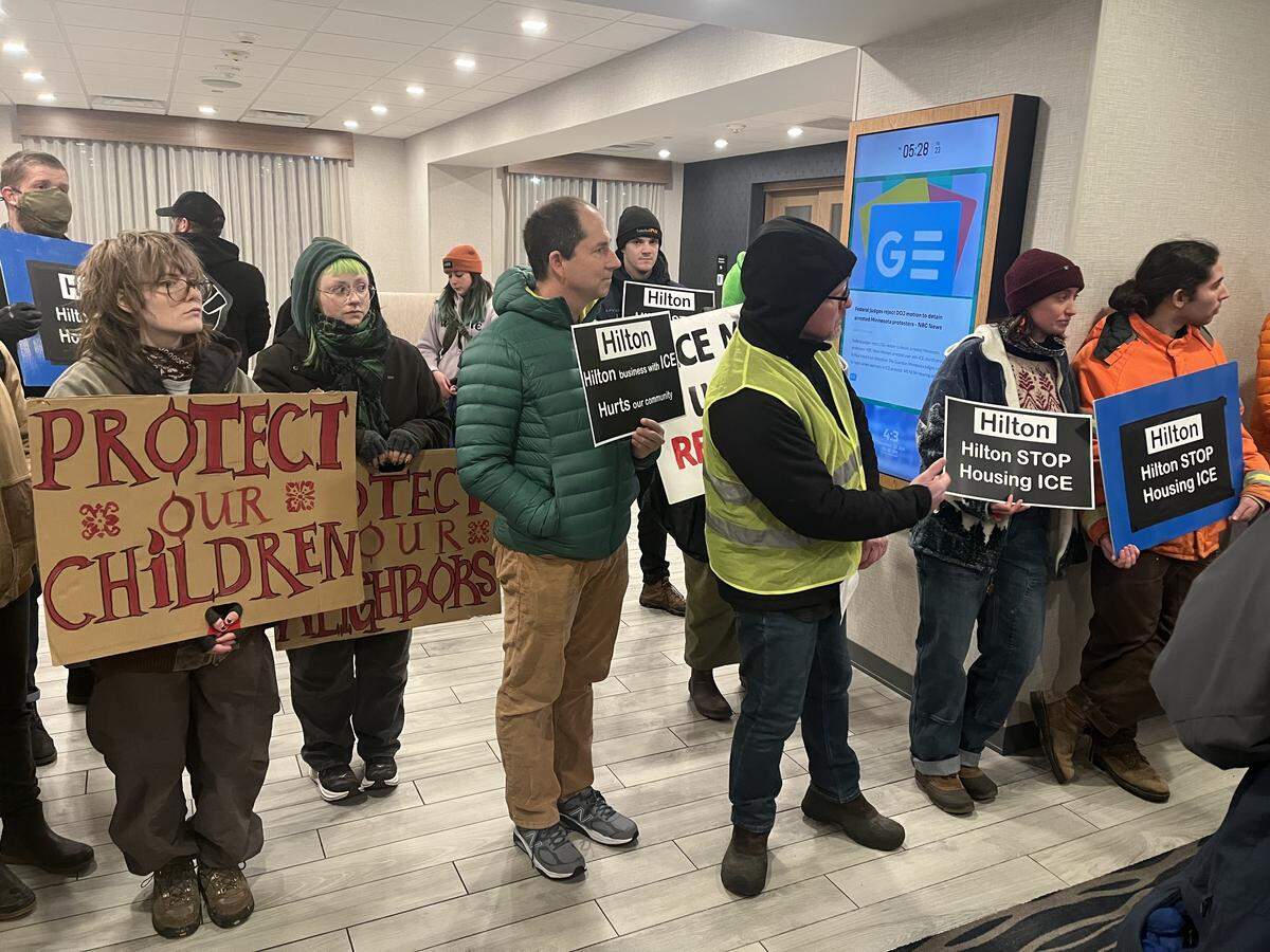 Dozens of community members gathered at the Hampton Inn Bellingham Airport on Friday night to demand that Hilton Hotels stop housing U.S. Immigration and Customs Enforcement (ICE) agents.