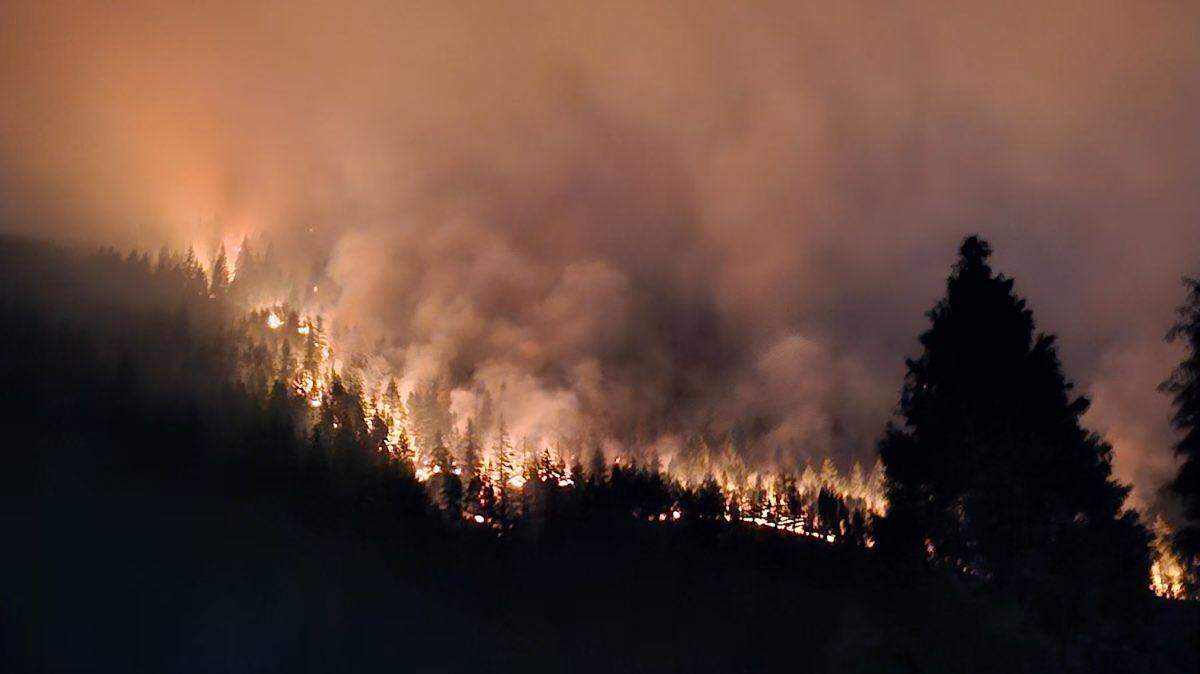 Flames from the Sourdough Fire inch close to the Diablo Dam on Wednesday night, Aug. 2, 2023.