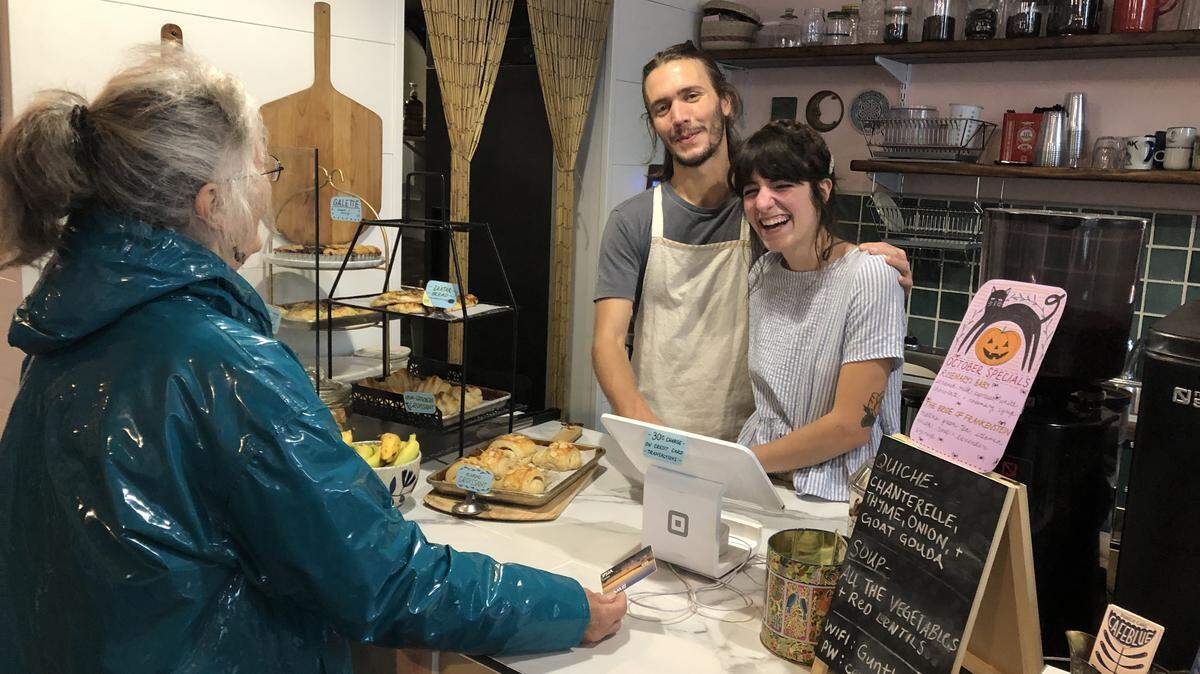 Cafe Blue owners Kyle Hooper and Lily Lovell chat with a customer in Bellingham, Wash.