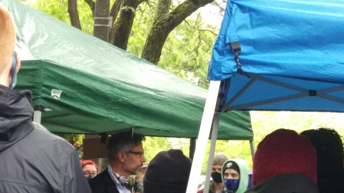 Bellingham Mayor Seth Fleetwood meets with March to Defund Police protesters under rain tarps at Railroad Avenue and Holly Street in downtown Bellingham Monday evening, June 15.