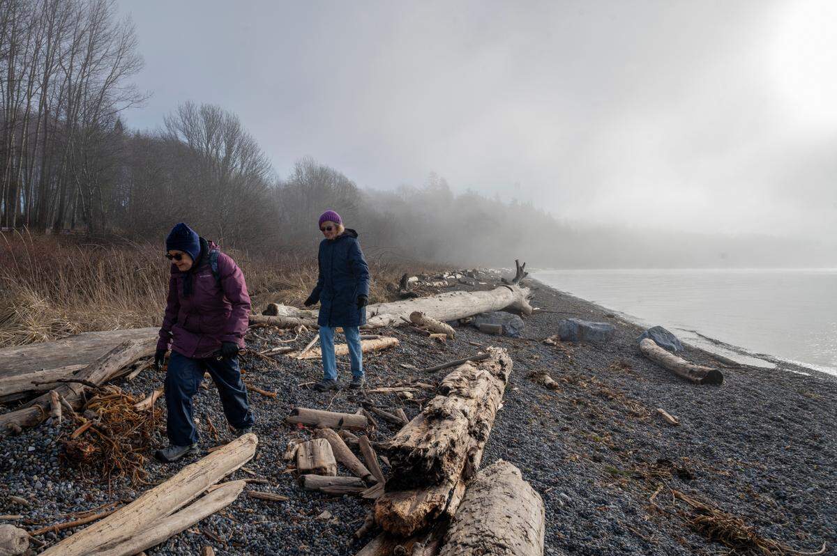 Laurita Whitford, left, and Judith Donaghue walk along the beach at the end of Gulf Road on Thursday, Jan. 27, near Ferndale. The two have been walking at this beach for 5 years and Whitford says they would be “devastated” to lose access. Whatcom County council members voted Feb. 8 to allow Pacific International Holdings to close the road to the public.