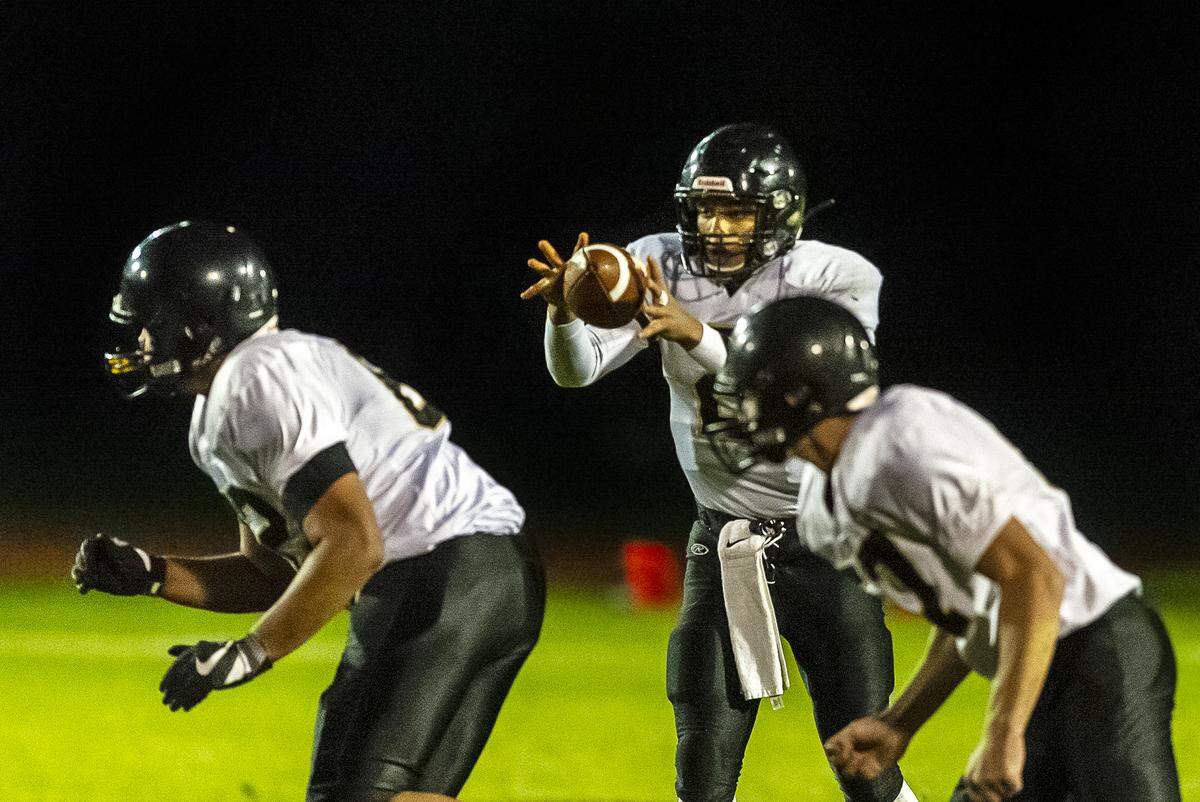 Meridian quarterback Cam Webster (2) takes a snap against Mount Baker Oct. 4. Though he never took a snap at quarterback before his senior season, Webster has led the Meridian football team into the Class 1A state playoffs and a showdown with unbeaten Montesano on Saturday.