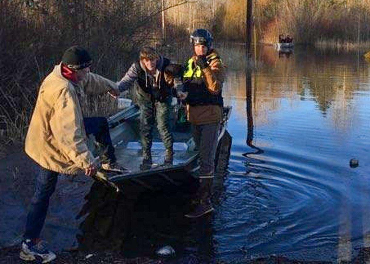 Whatcom County Search and Rescue personnel evacuate residents in Marietta Saturday.