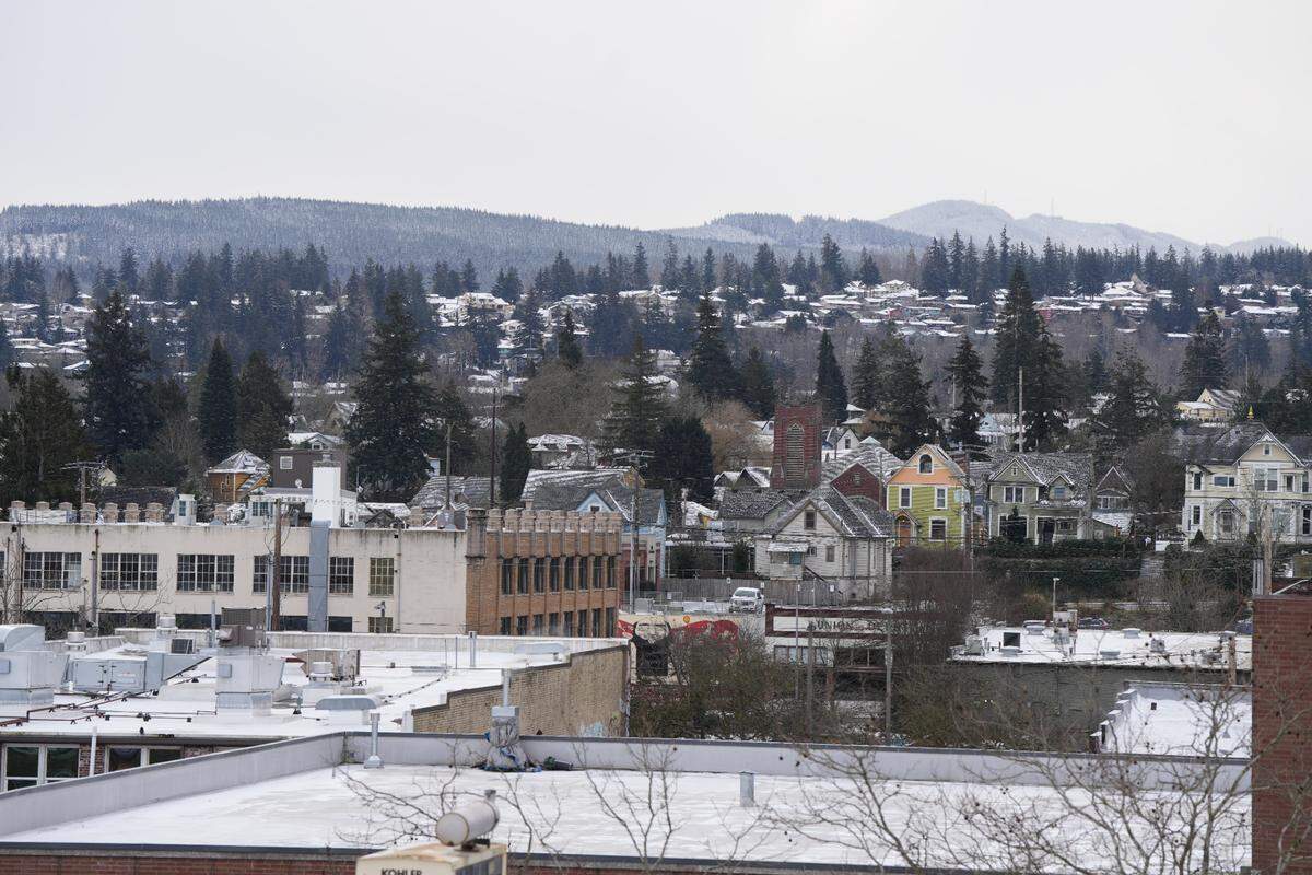 Downtown rooftops are dusted in snow on the morning of February 3, 2025, in Bellingham, Wash.