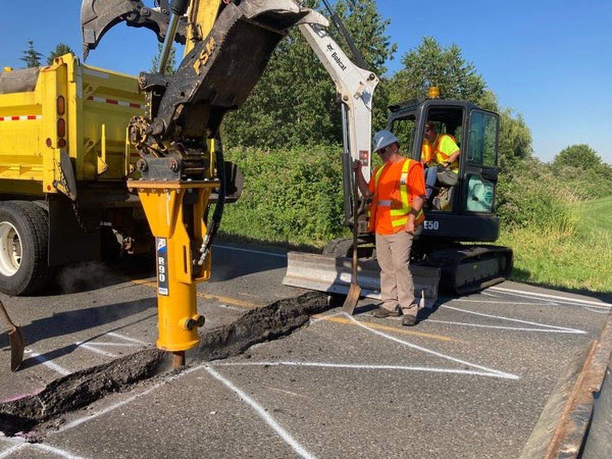 Washington State Department of Transportation crews work Monday, June 28, to repair State Route 544 near East of Everson. The Road had to be closed Sunday after the weekend’s extreme heat caused the road to buckle.