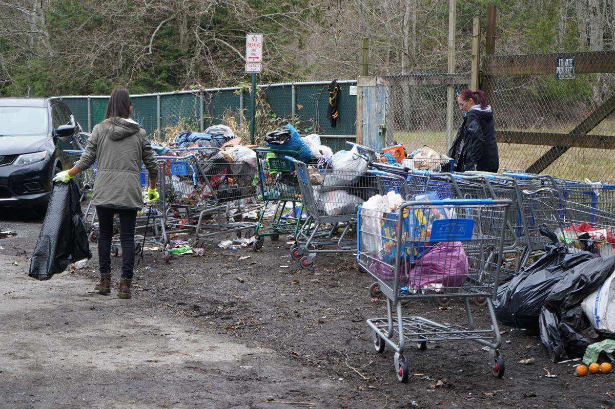 Volunteers joined residents of the encampment behind Walmart to help clean up trash on Dec. 29, 2023, in Bellingham, Wash.