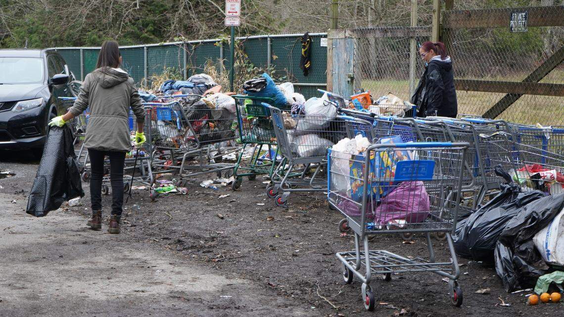 Volunteers joined residents of the encampment behind Walmart to help clean up trash on Dec. 29, 2023, in Bellingham, Wash.