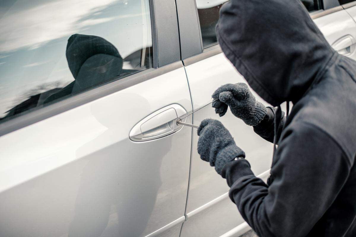 Man stealing a car, car jacking stock photo