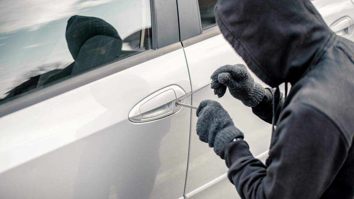 Man stealing a car, car jacking stock photo