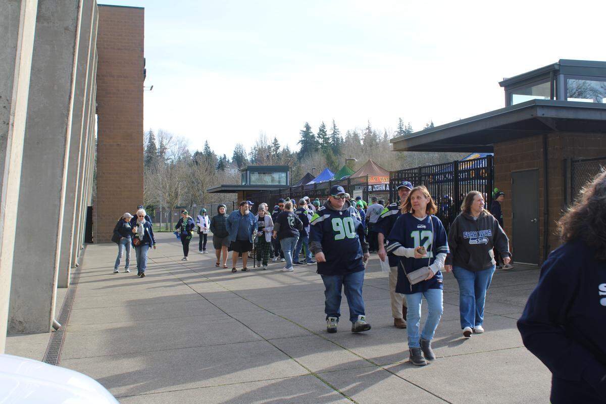 Fans walk toward Civic Stadium on Friday, prior to the formation of a human 12 in honor of the Seahawks’ return to the Super Bowl.