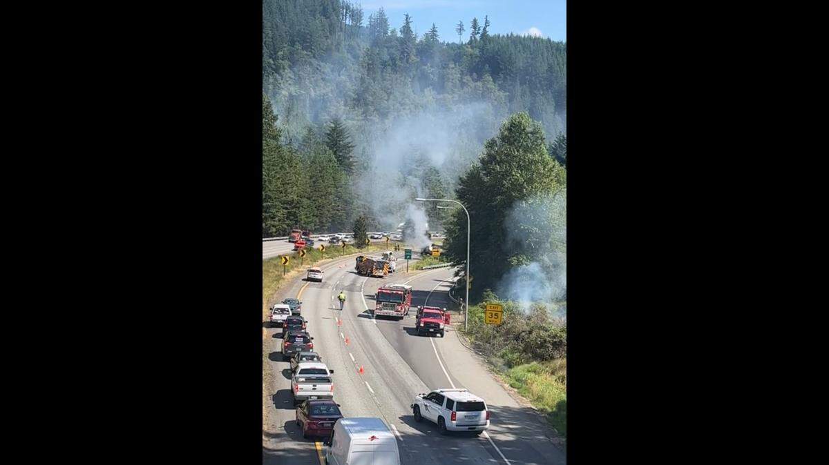 Traffic is blocked along I-5 South near Bellingham while fire crews work to extinguish a roadside brush fire.
