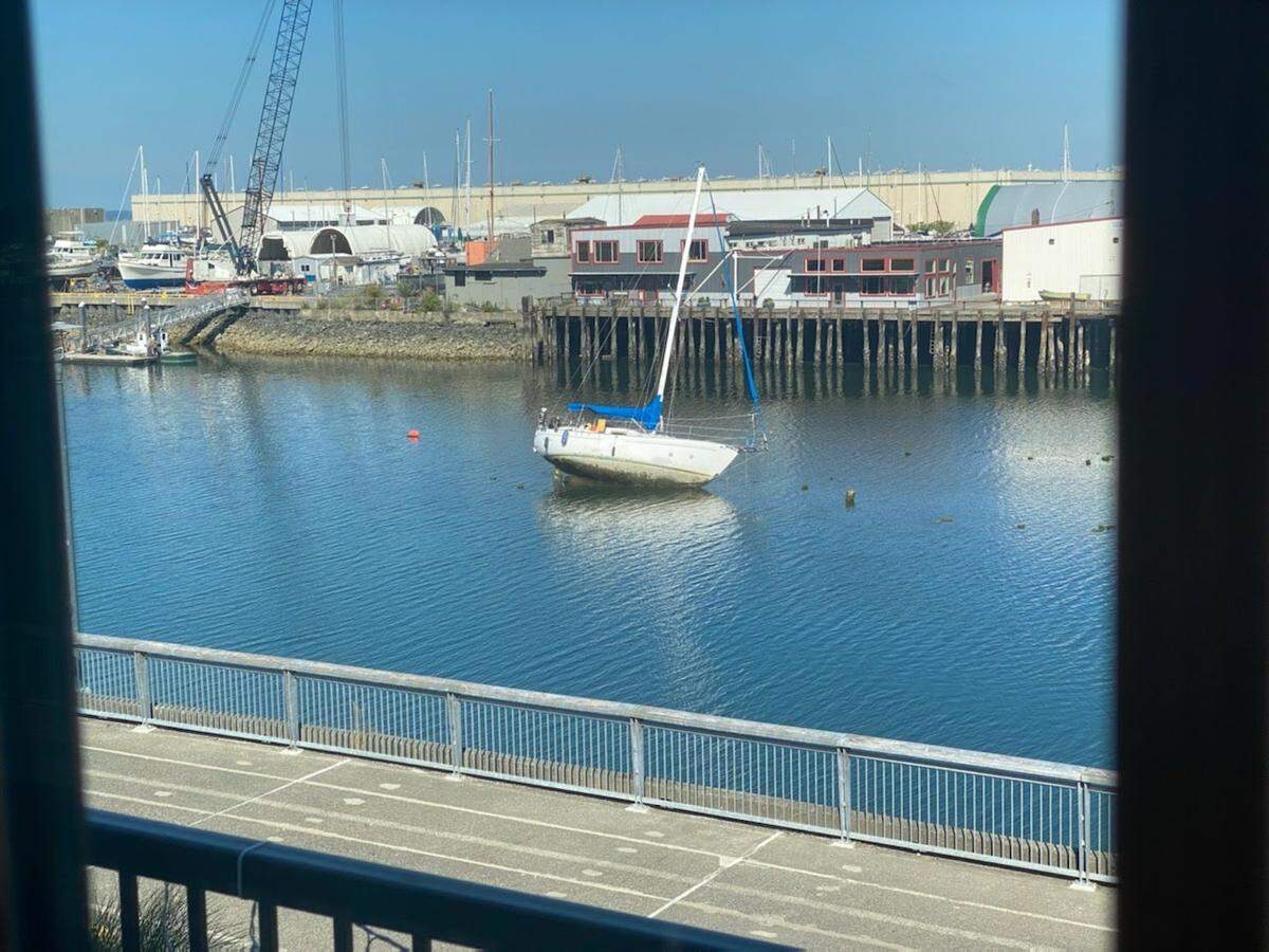 A 36-foot sailboat is grounded Monday, July 25, in the Whatcom Creek Waterway near the Granary Building in Bellingham.