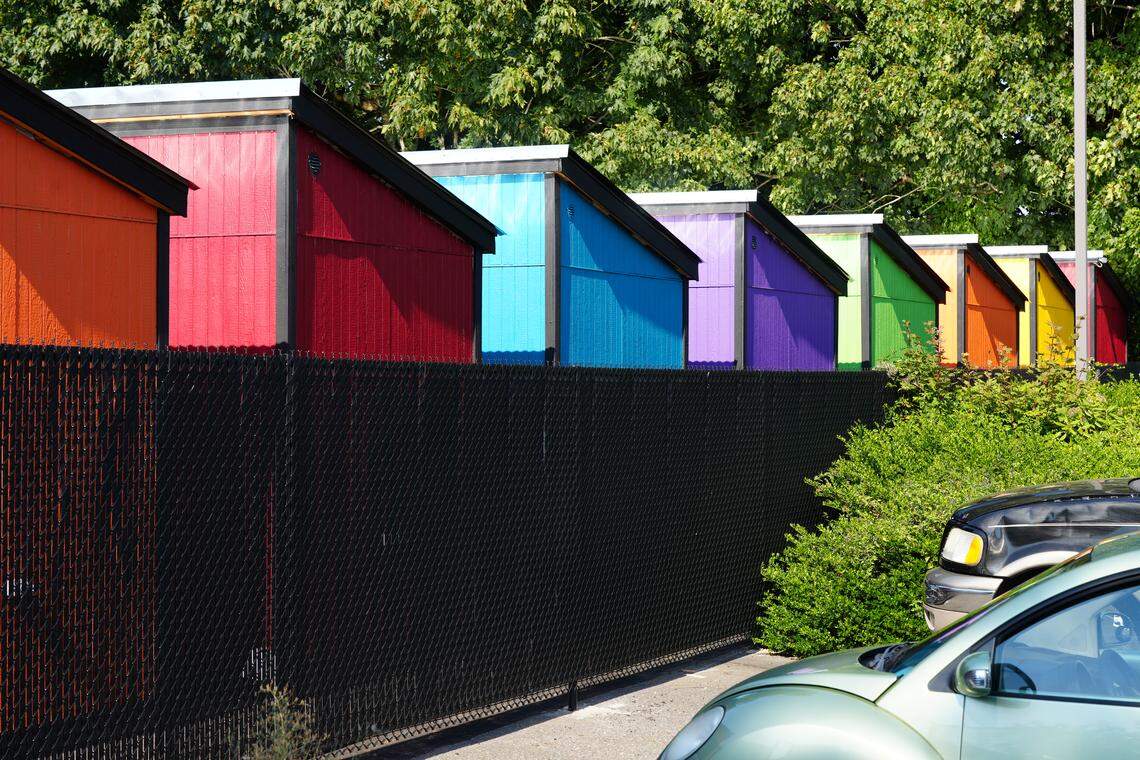 Multiple tiny homes stand behind a fence in the North Haven village.
