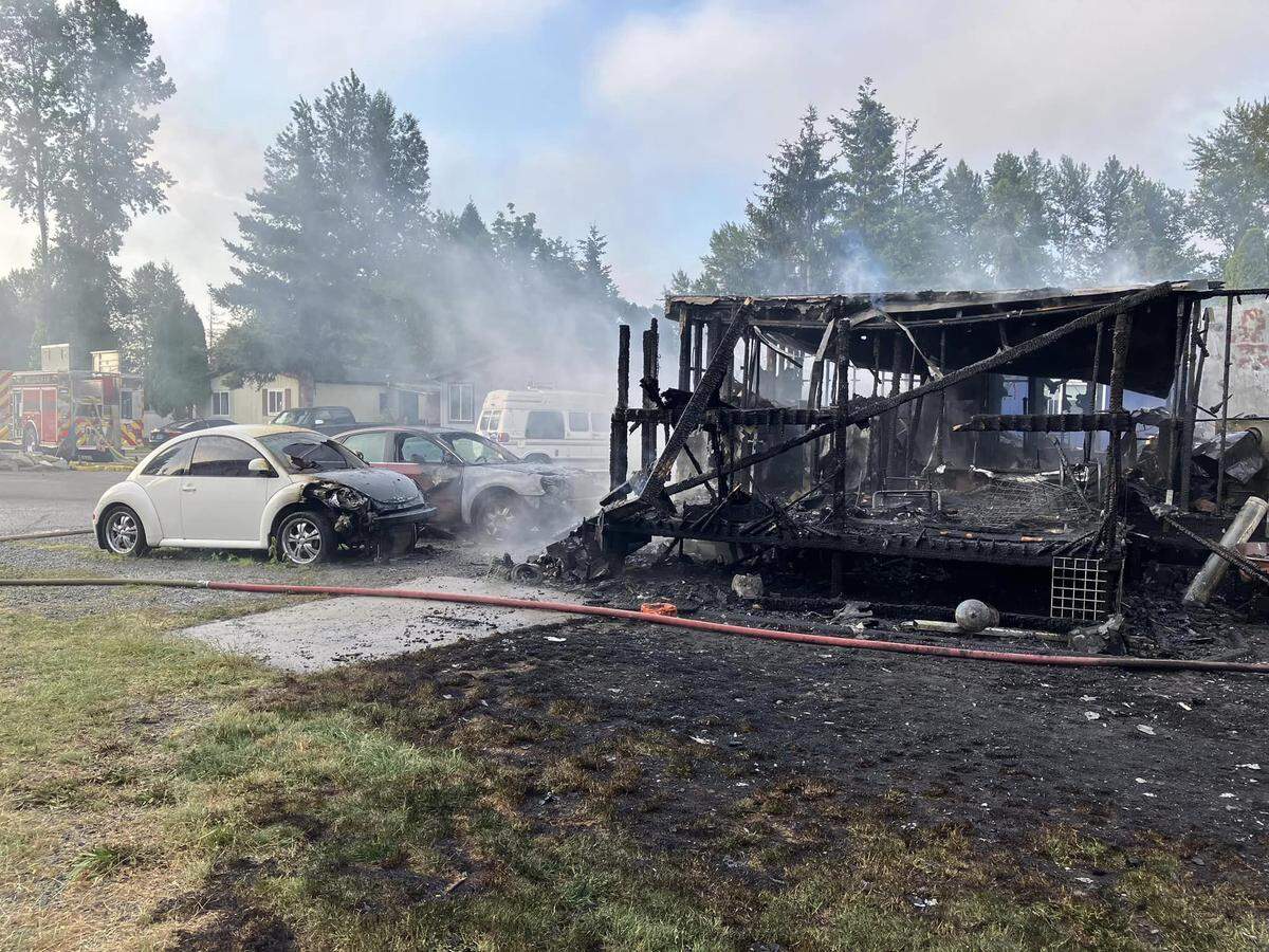A mobile home was completely destroyed by a fire on June 25, 2023, at the Bakerview Estates mobile home community in Bellingham, Wash. Two vehicles were also damaged by the flames.