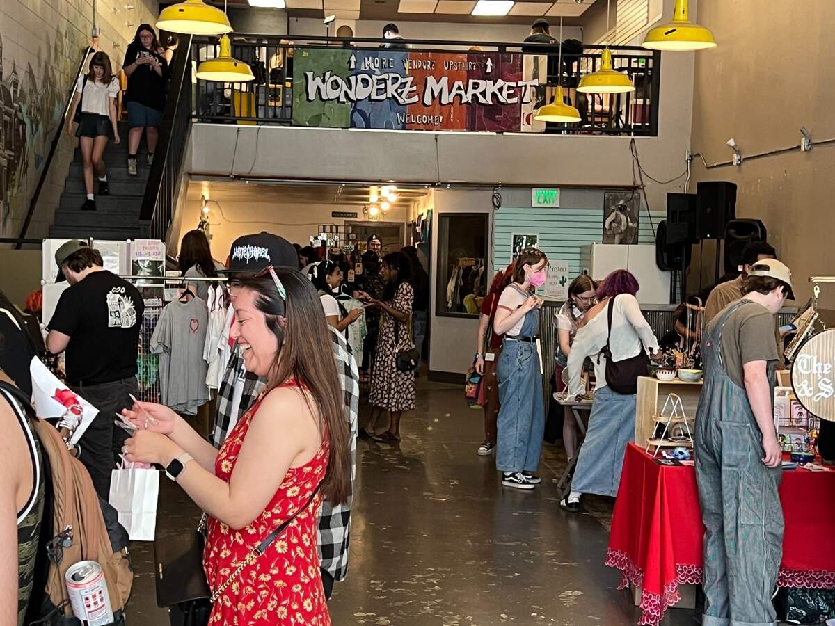 Shoppers browse the booths at Wonderz Market in Bellingham.