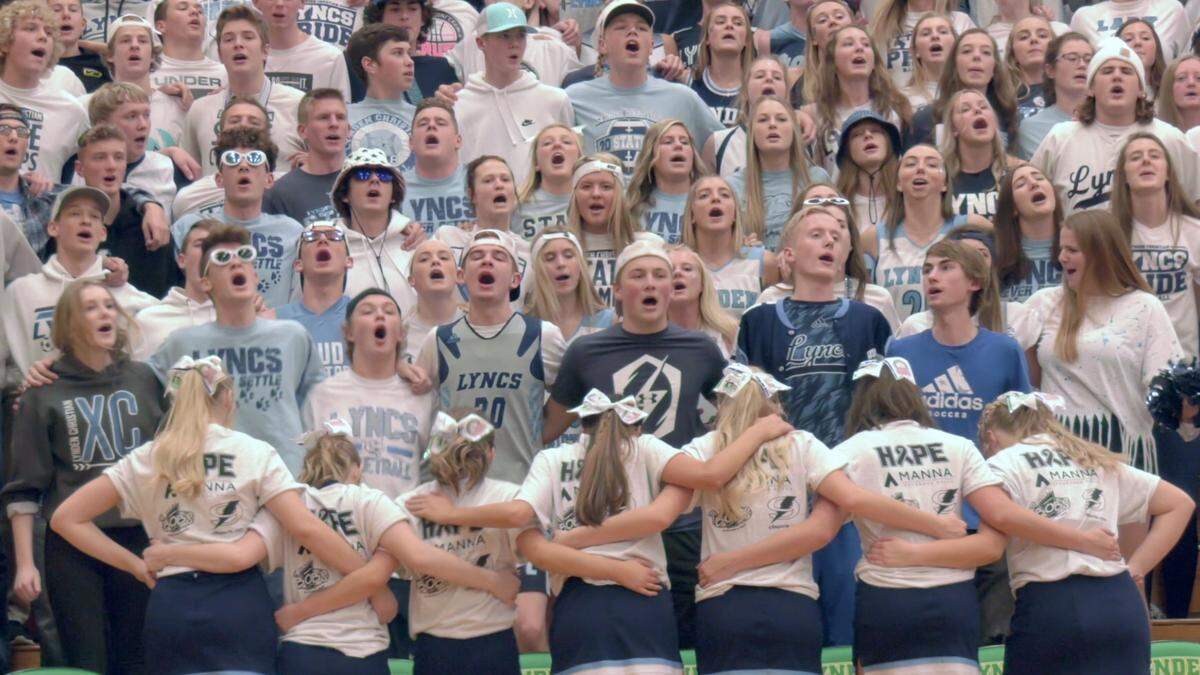 Lynden Christian fans and cheerleaders cheer together during the Lynden vs. Lynden Christian basketball game at Lynden High School on Jan. 25.