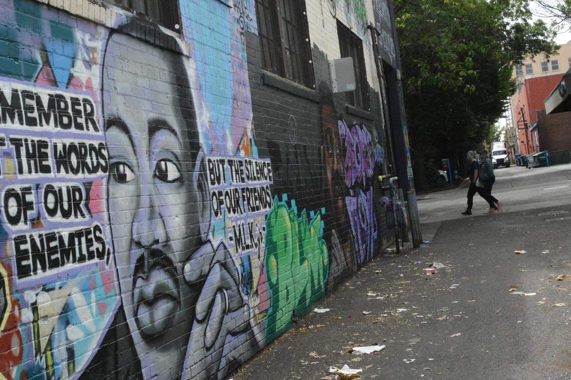 Murals of Martin Luther King and George Floyd are in an alley off Magnolia Street in downtown Bellingham. They were defaced with Patriot Front logos sometime after Sunday, Aug. 2.